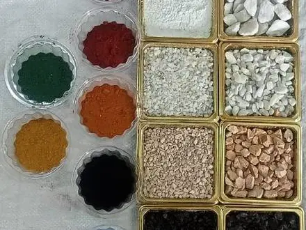 bowls of colored pigments and stone aggregates used to mix custom terrazzo