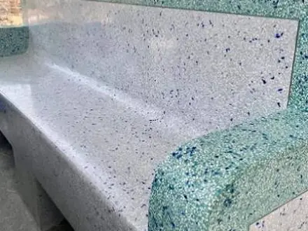 an outdoor bench finished in blue and white terrazzo