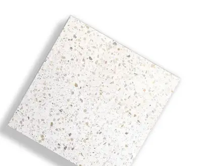a terrazzo tile sample with flecks of stone in a light finish
